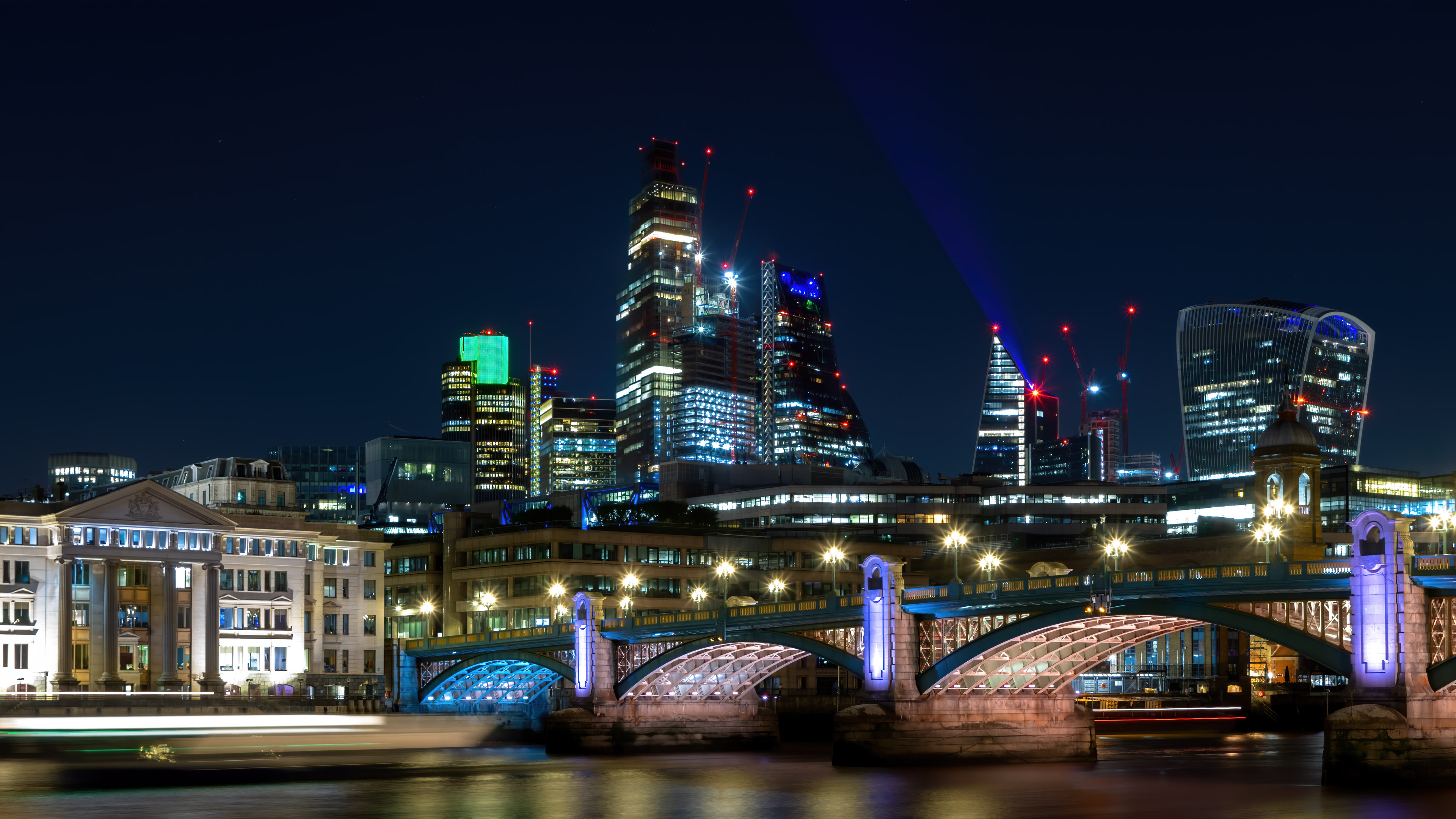 Get lost in the beauty of London's cityscape at night with our stunning wallpaper.