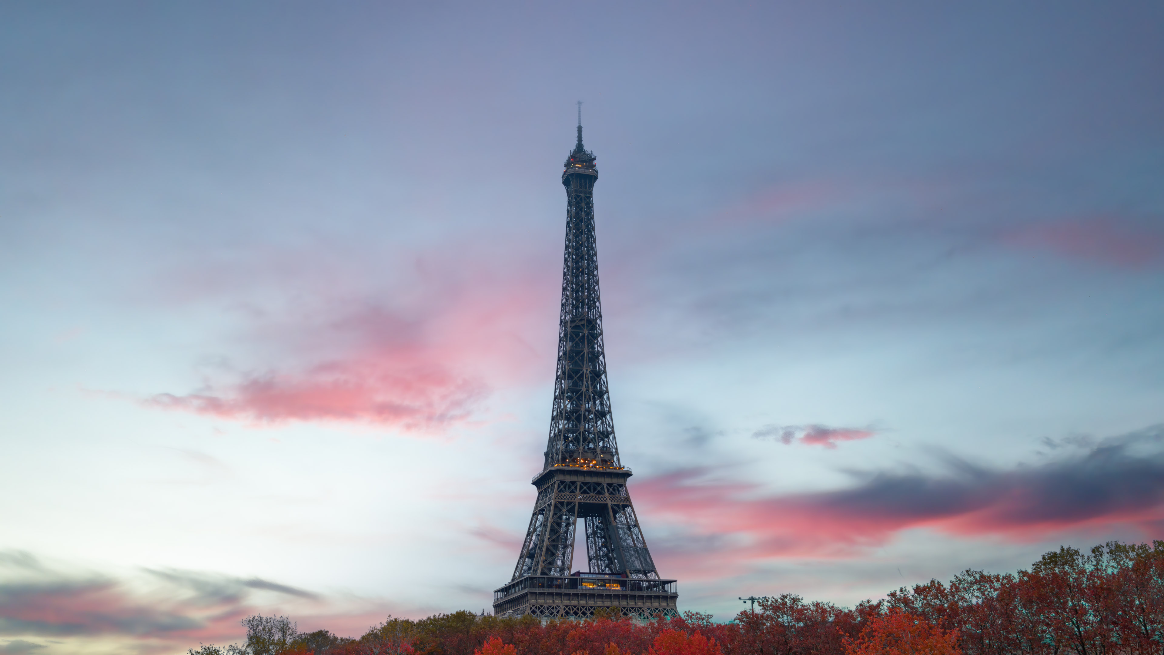 Transport yourself to the enchanting city of Paris with our 4K wallpaper, featuring the iconic Eiffel Tower against a stunning backdrop.