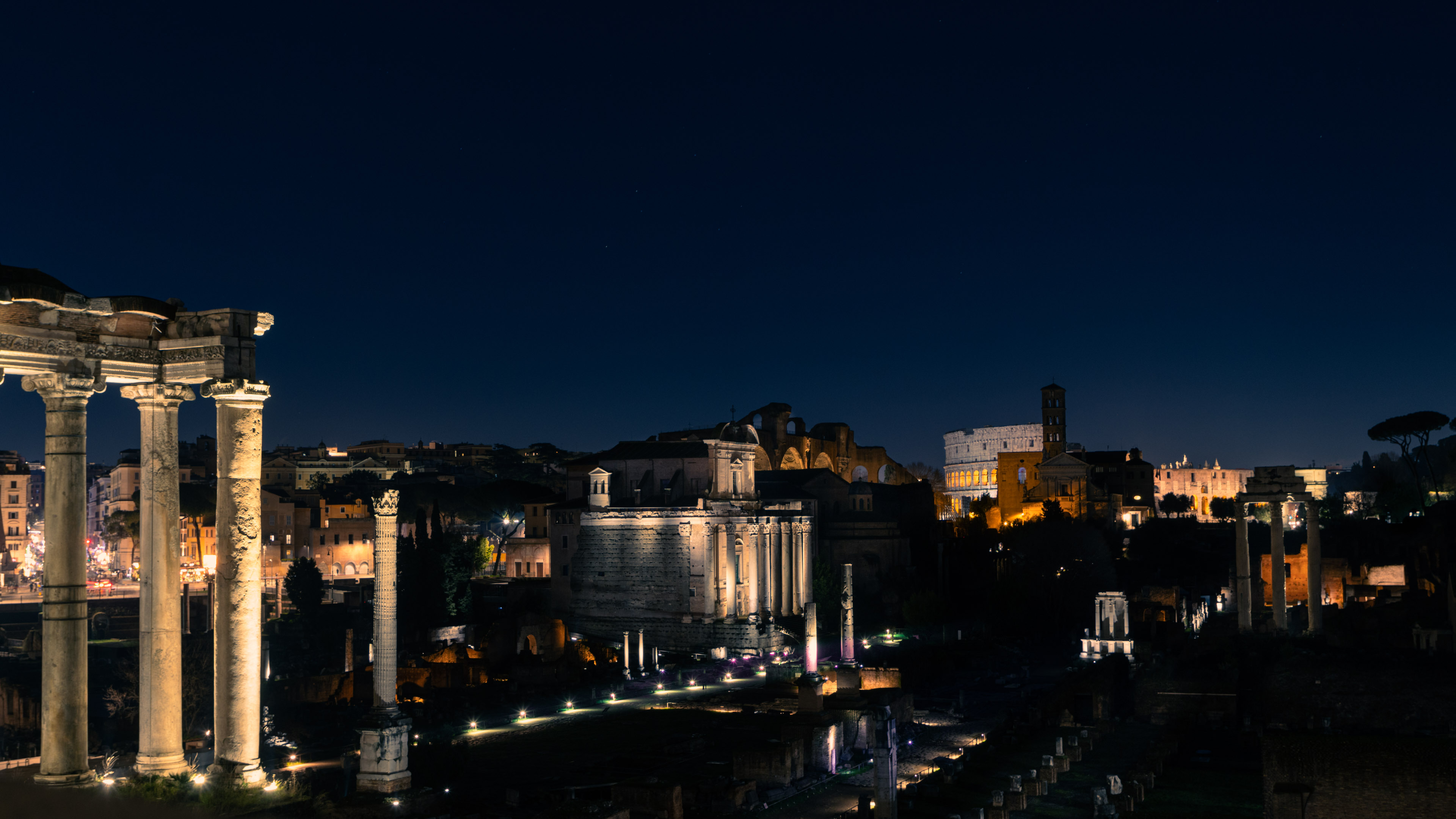 Experience the enchanting allure of Rome at night through our captivating wallpaper, highlighting the city's timeless beauty.