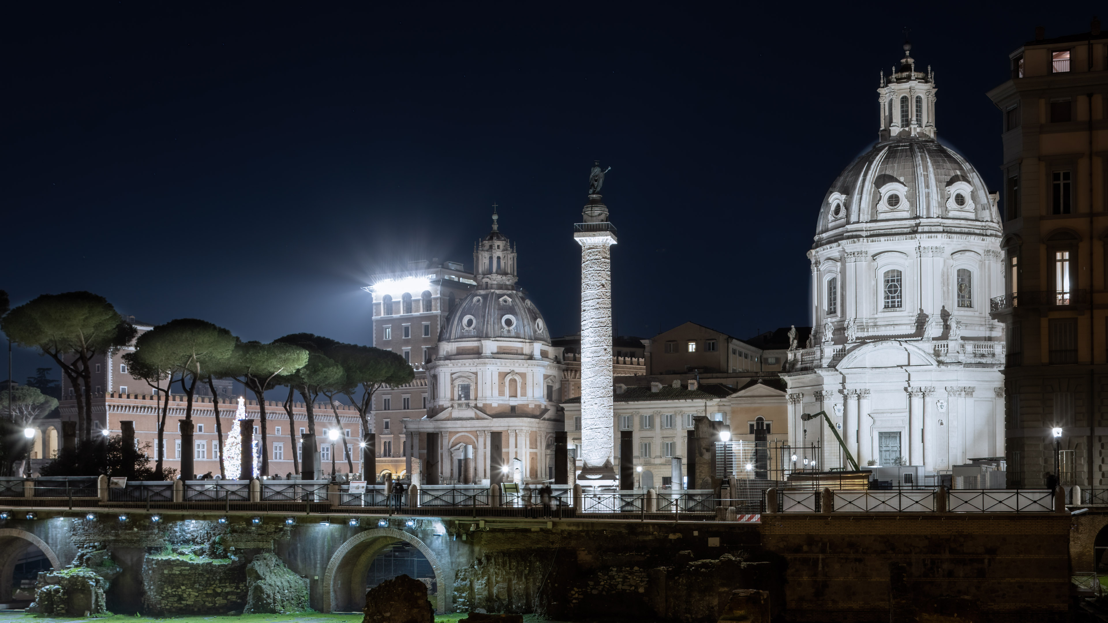 Experience the beauty of impressive Rome cityscape at night with illuminated buildings.