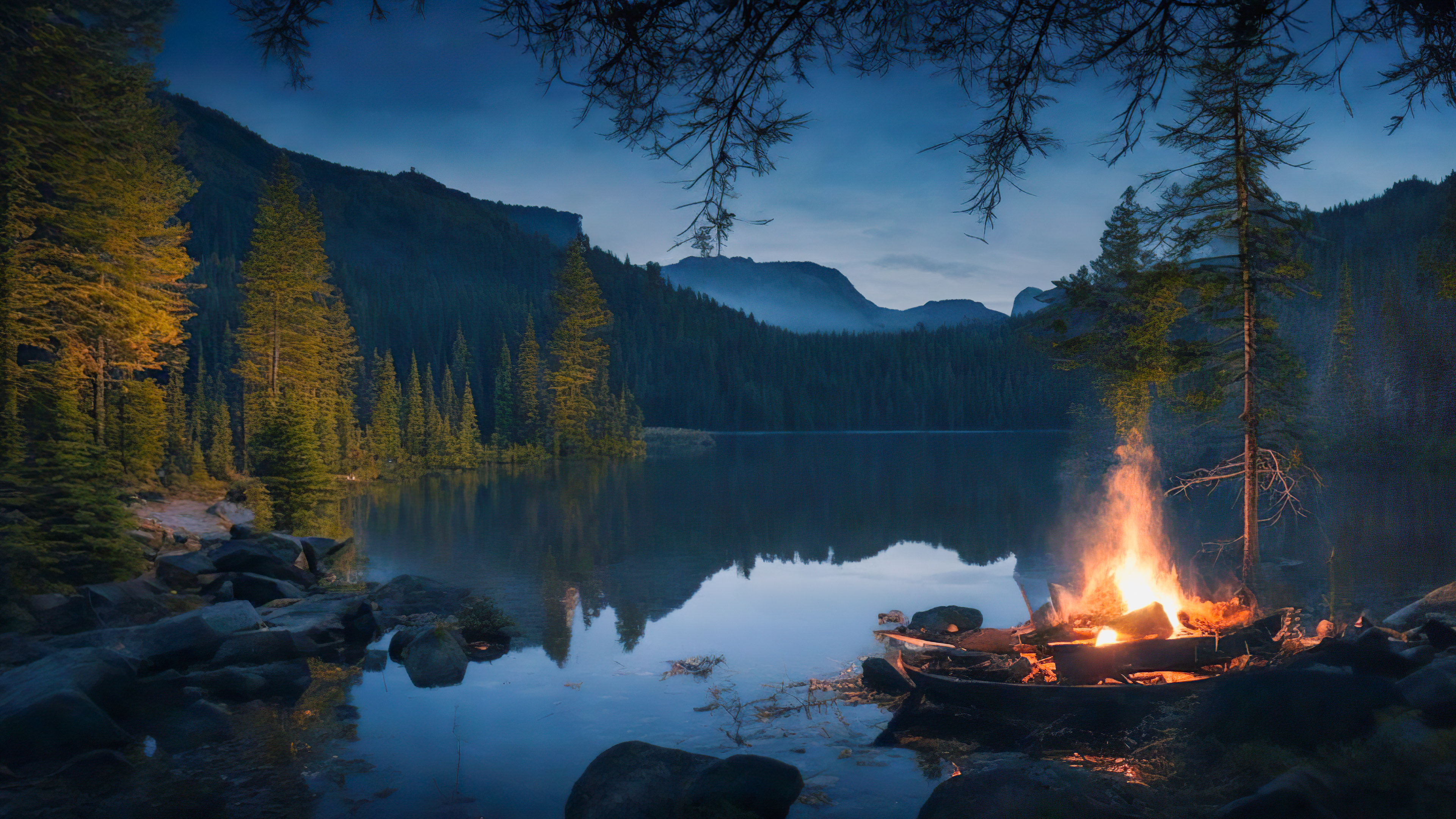Transform your PC with our desktop nature wallpaper in HD, showcasing a serene lakeside campsite and a flickering campfire, surrounded by a dark, wooded wilderness, and feel the tranquility seep into your workspace.