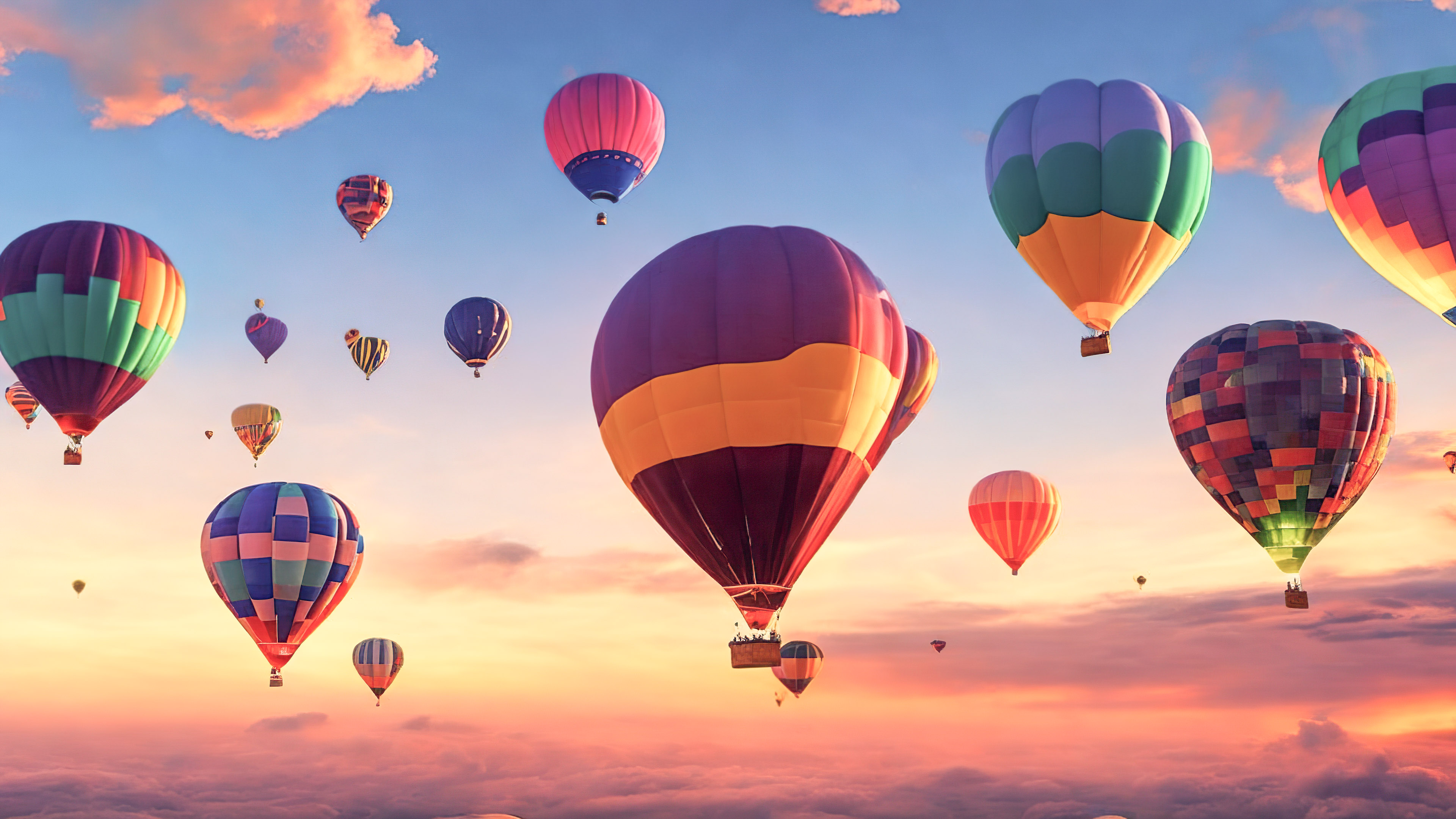 Adorn your PC with our beautiful nature wallpaper, presenting a whimsical and dreamy sky filled with floating, colorful hot air balloons at sunrise.