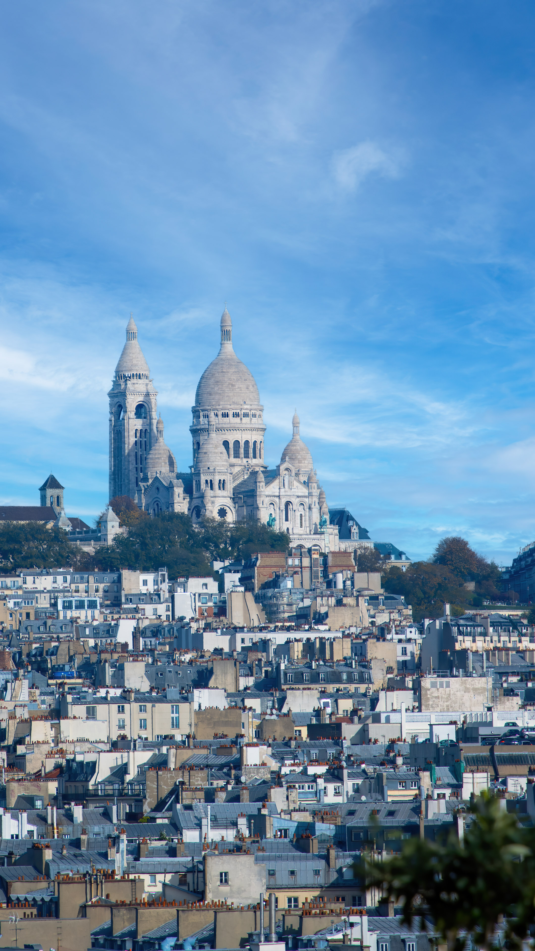 Gorgeous cityscape wallpaper of Paris featuring the beautiful Montmartre, the iconic Sacré-Cœur Basilica and the city's famous landmarks in the background.
