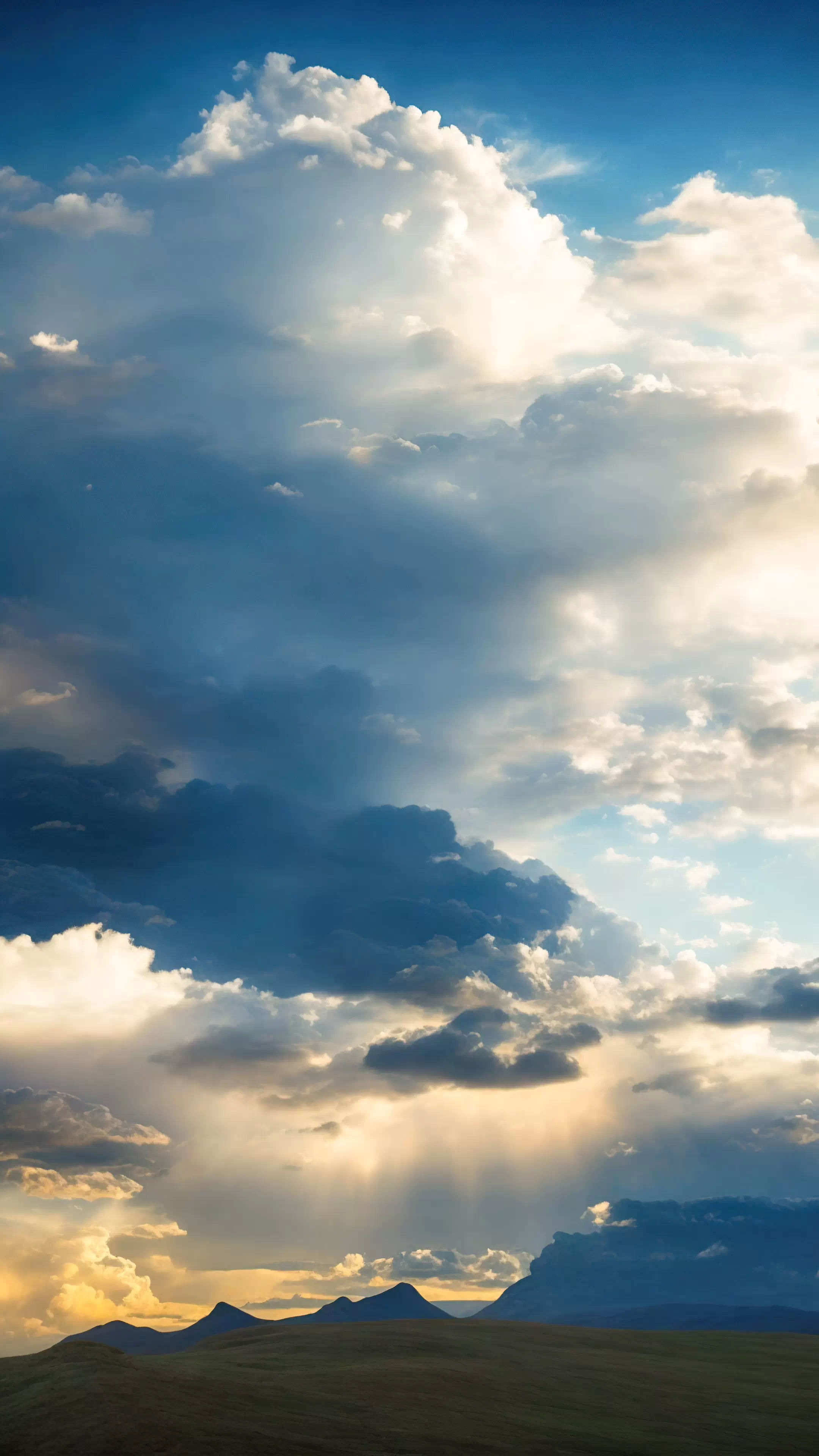 Découvrez le drame d'une vallée ensoleillée sous un ciel dramatique avec des nuages projetant des ombres, avec notre fond d'écran nature en Full HD, et laissez votre écran devenir une porte vers la grandeur des paysages de la nature.