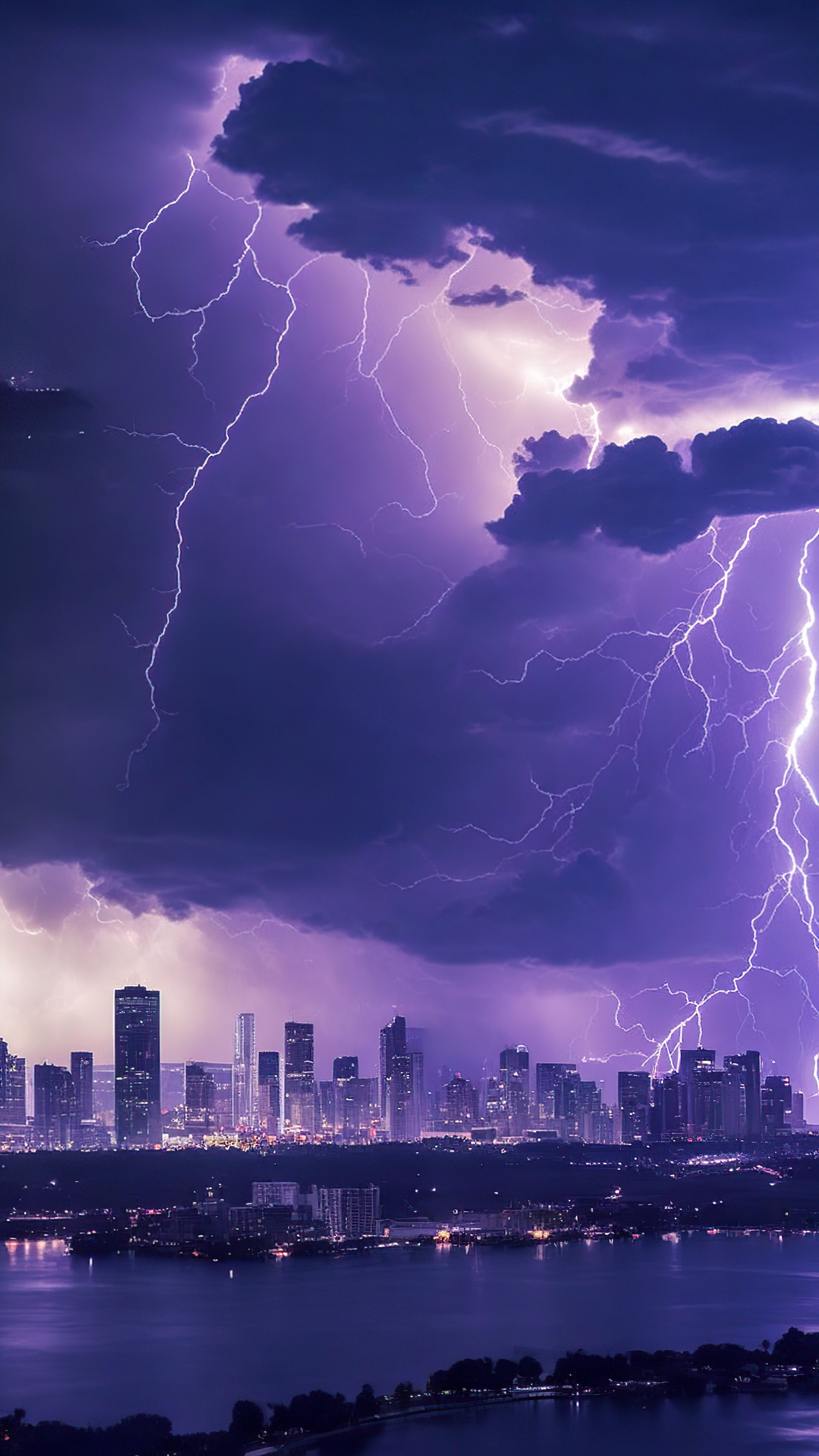 Experience the thrill of an epic thunderstorm brewing over a city skyline, with lightning bolts illuminating the dark clouds, with this cool sky wallpaper.