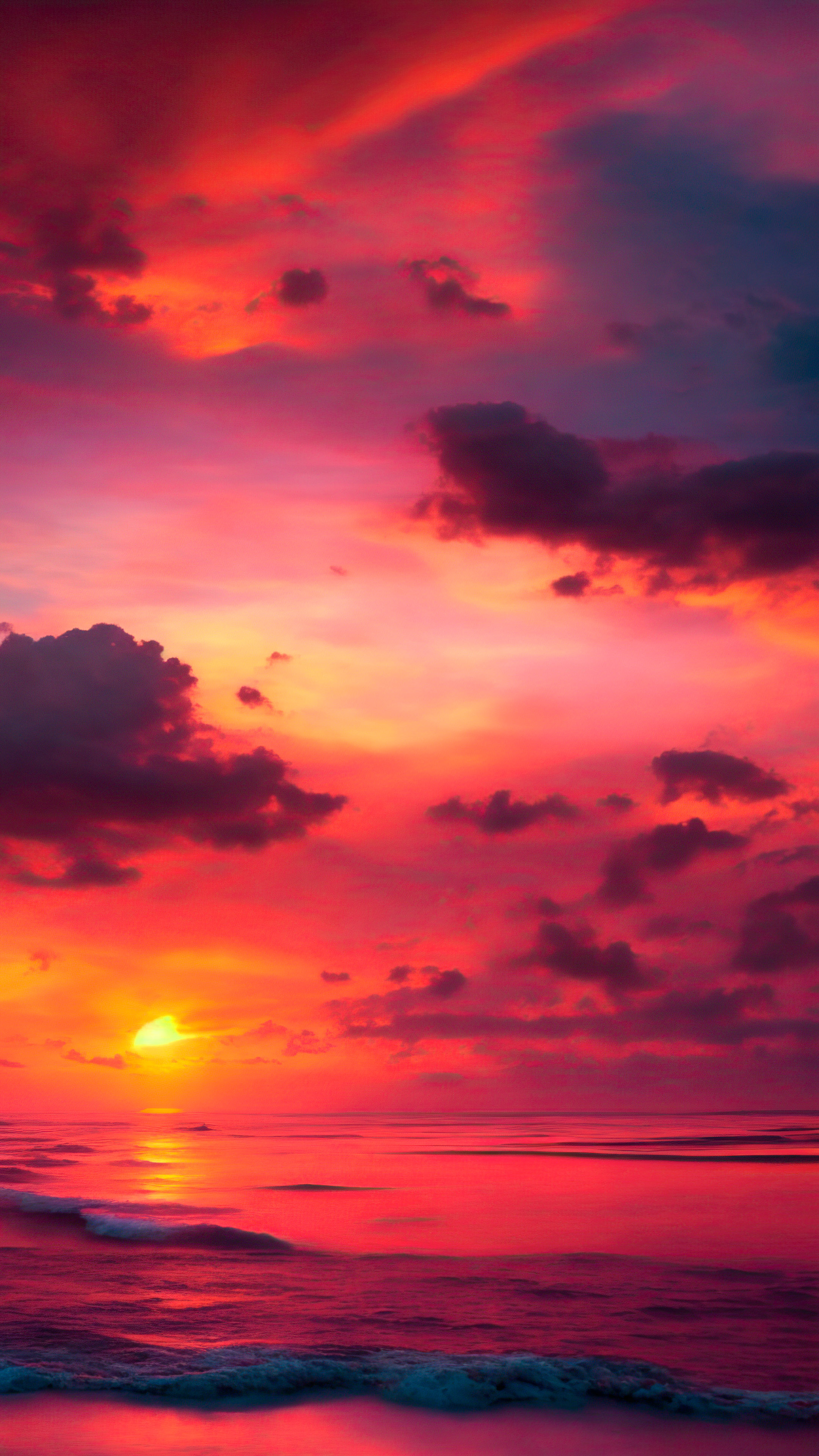 Ornez votre écran iOS avec notre arrière-plan de ciel pour iPhone, présentant un coucher de soleil hypnotisant sur un océan expansif, avec des teintes ardentes d'orange et de rose.